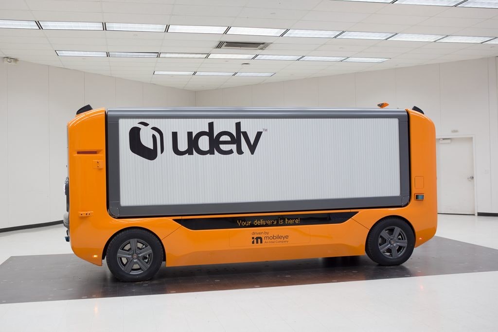 照片中提到了Mudelv、Your delivery is here!、driven by，包含了汽車、消費電子展 2022、汽車、電動車、特斯拉Model 3